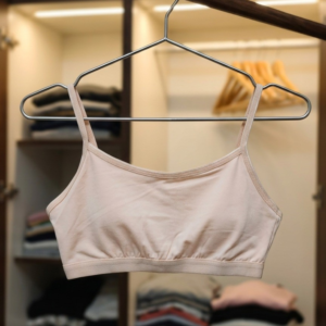 Softellewear ladies lounge bra set folded on wooden shelf in beige and pink colors